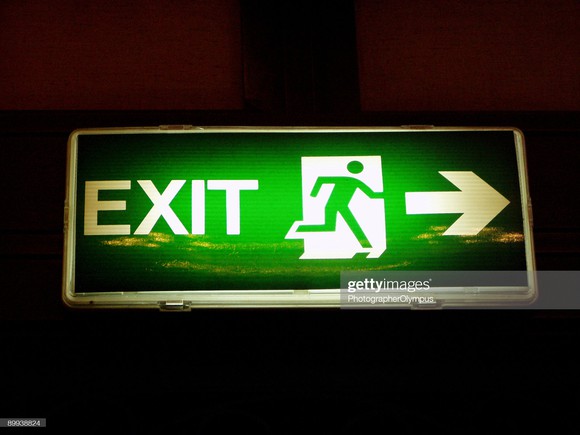 Green Exit sign with arrow pointing the way.