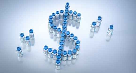 Vaccine vials forming a dollar sign.