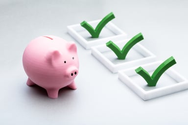 Checks on boxes next to piggy bank