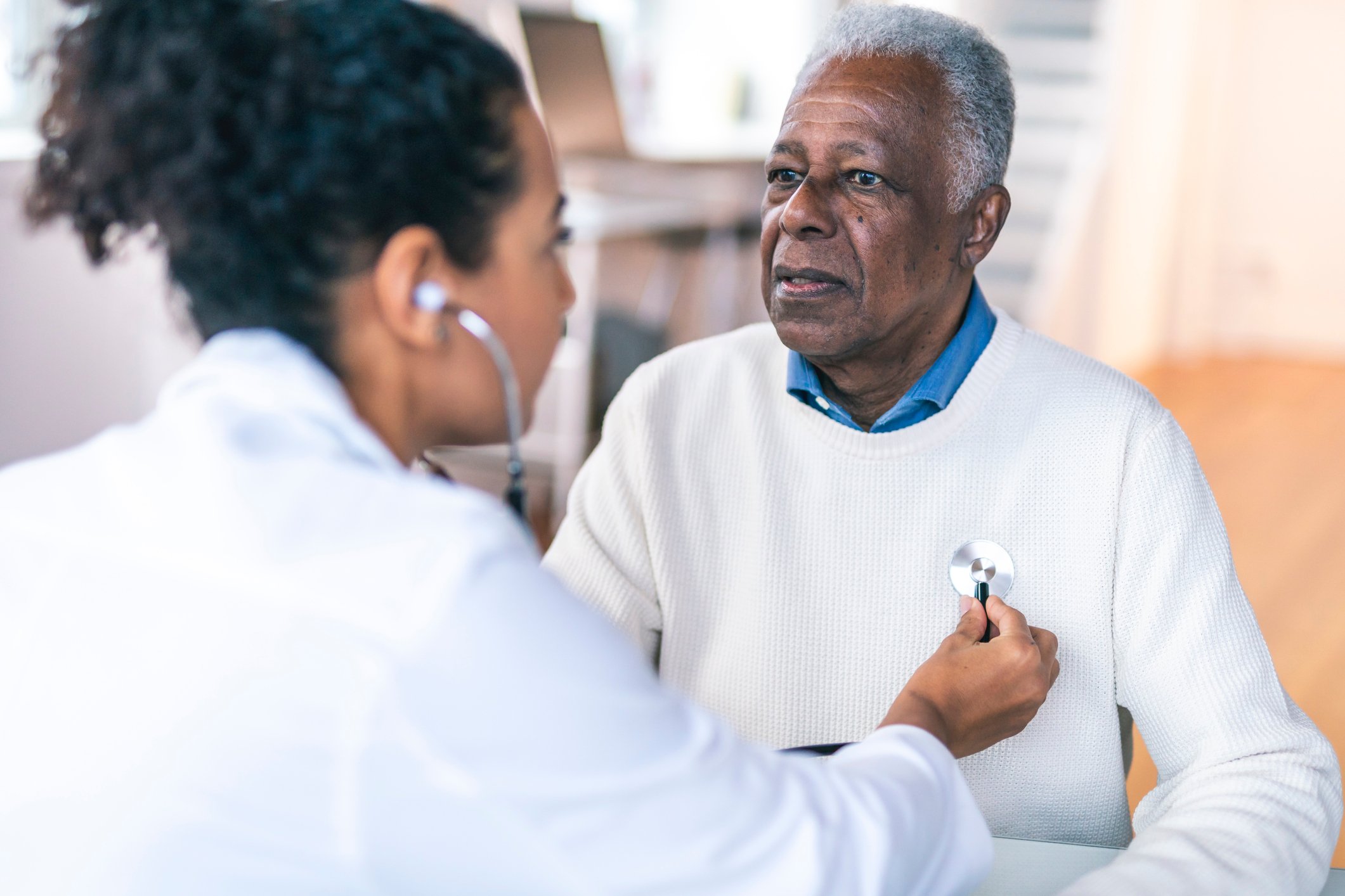 A doctor checking a patient's heart.