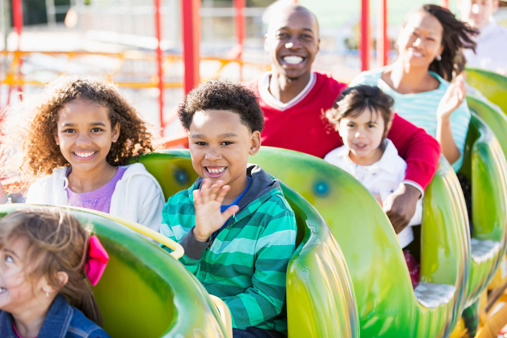 A family on a ride at a theme park.
