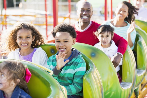 A family on a ride at a theme park.