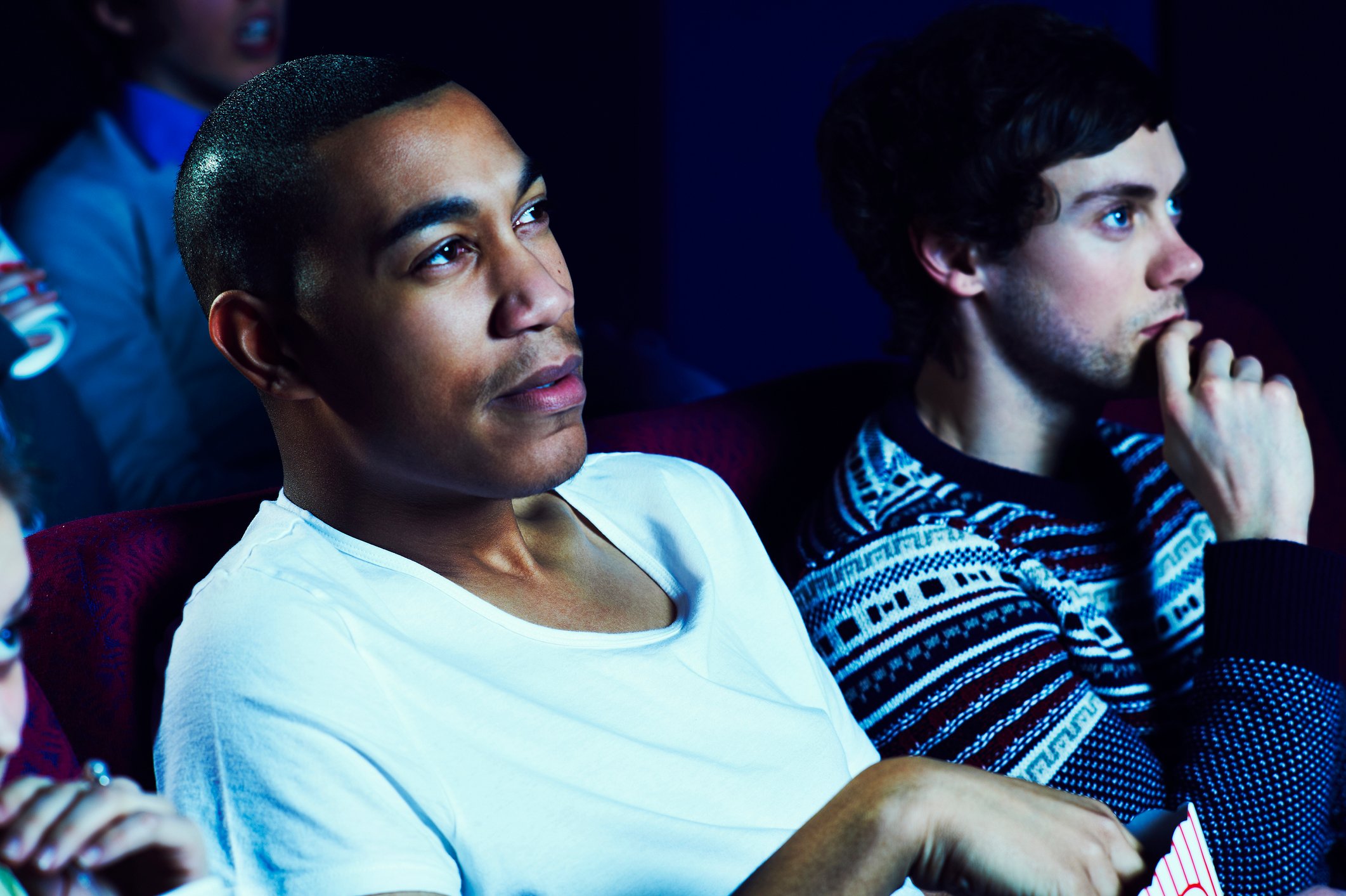 Two people watching movie in theater