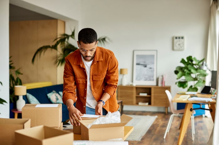 Person unpacking delivered goods. 