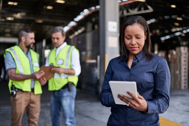 A woman using a tablet at a factory site