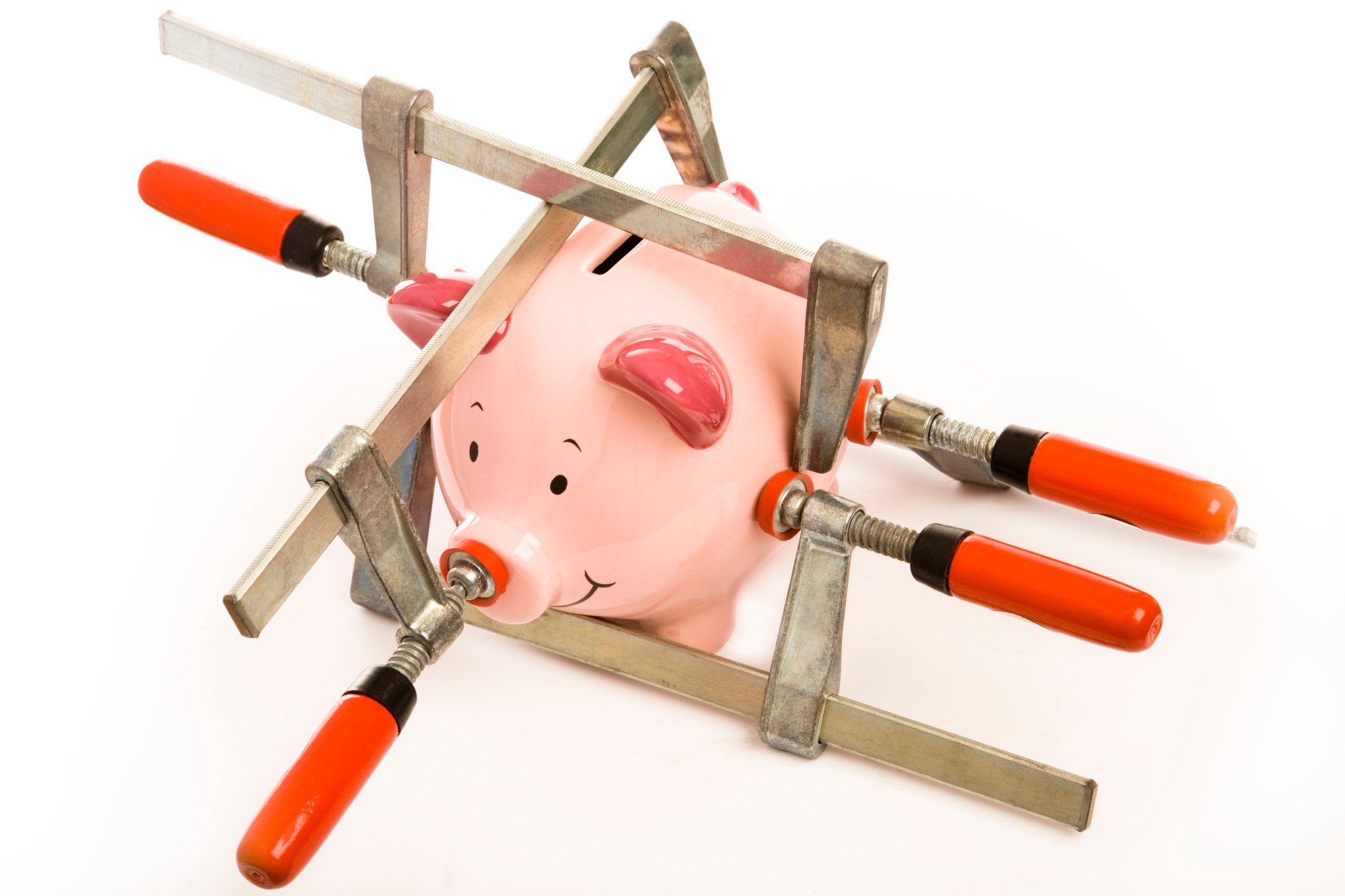 a piggy bank has stress clamps pushing in on it from different directions