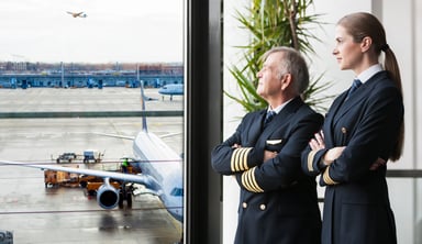 Airline Pilots Looking Through Window