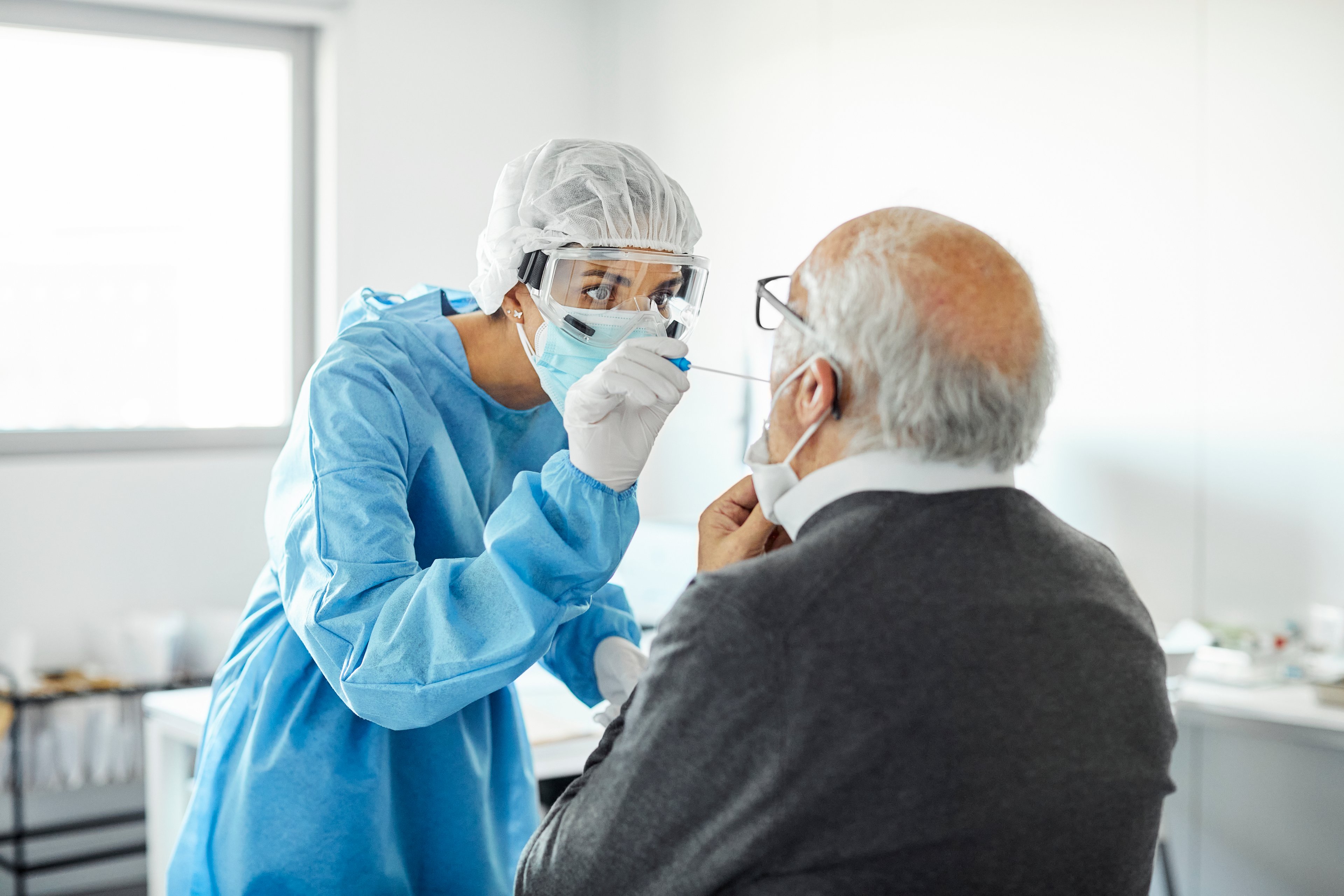Nurse taking a nasal swab for coronavirus testing. 