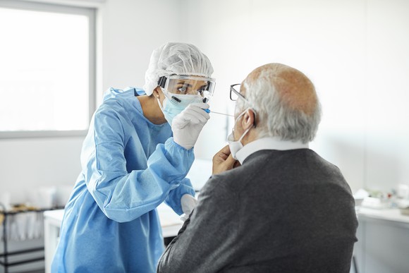 Nurse taking a nasal swab for coronavirus testing. 