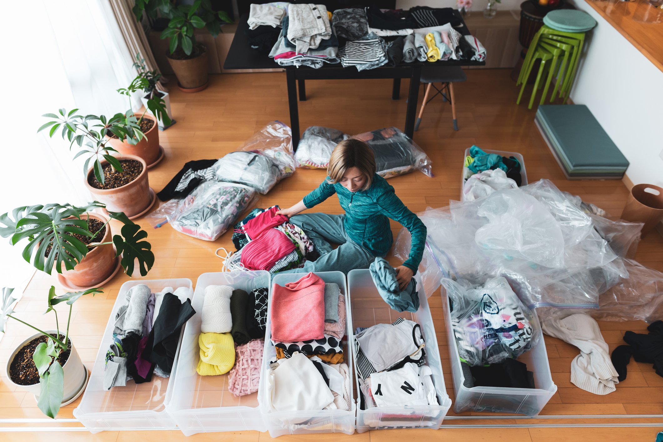 Woman sorting clothes in bin