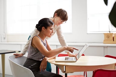 two_women_working_on_laptop