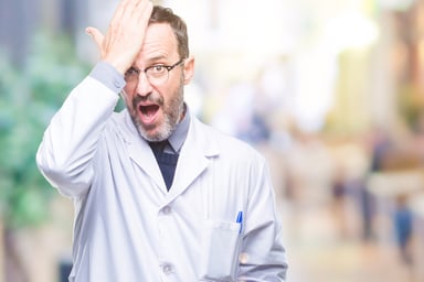 Scientist with hand on head