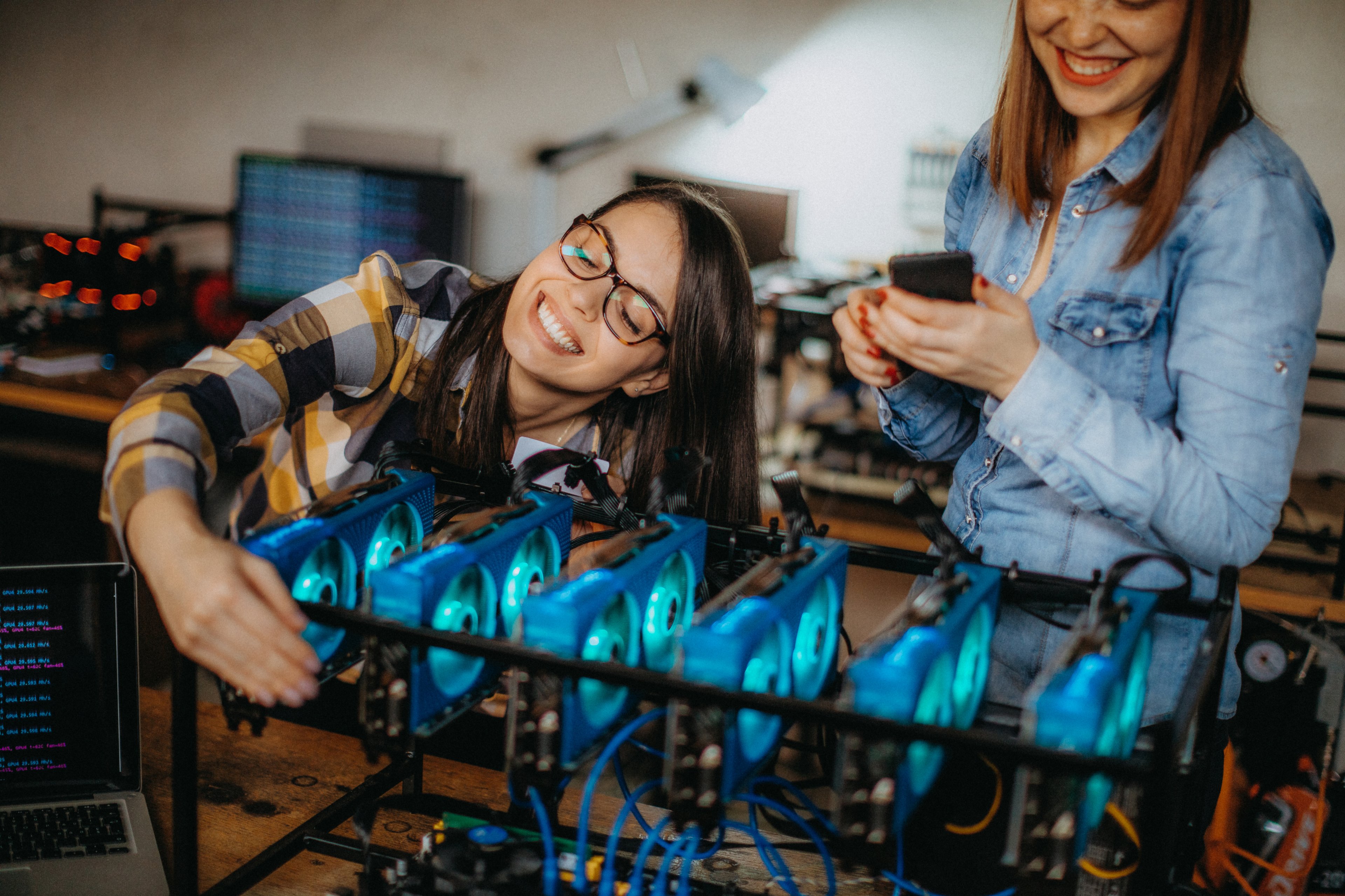 Business owners configuring a Bitcoin mining rig. 