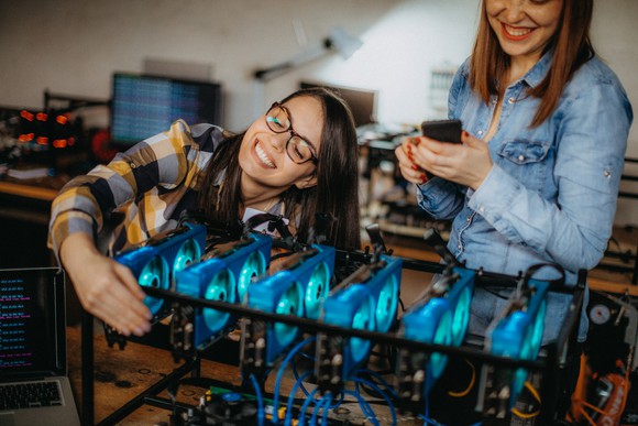Business owners configuring a Bitcoin mining rig. 