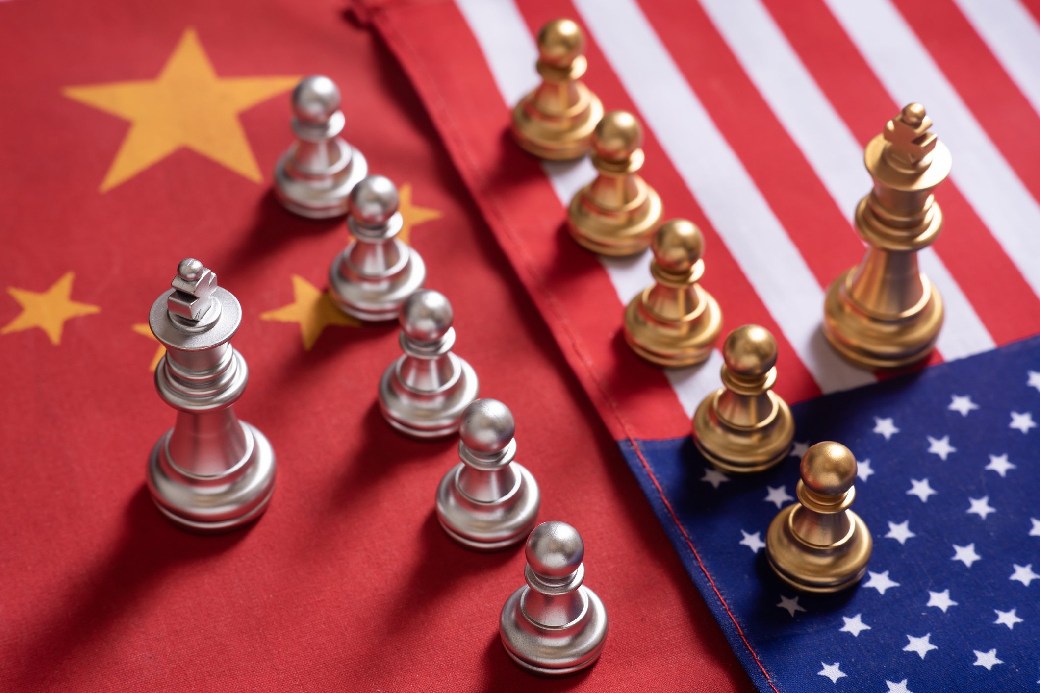 Chess pieces placed atop Chinese and American flags.