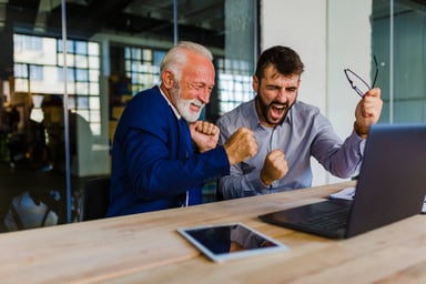 GettyImages-two investors cheer_computer