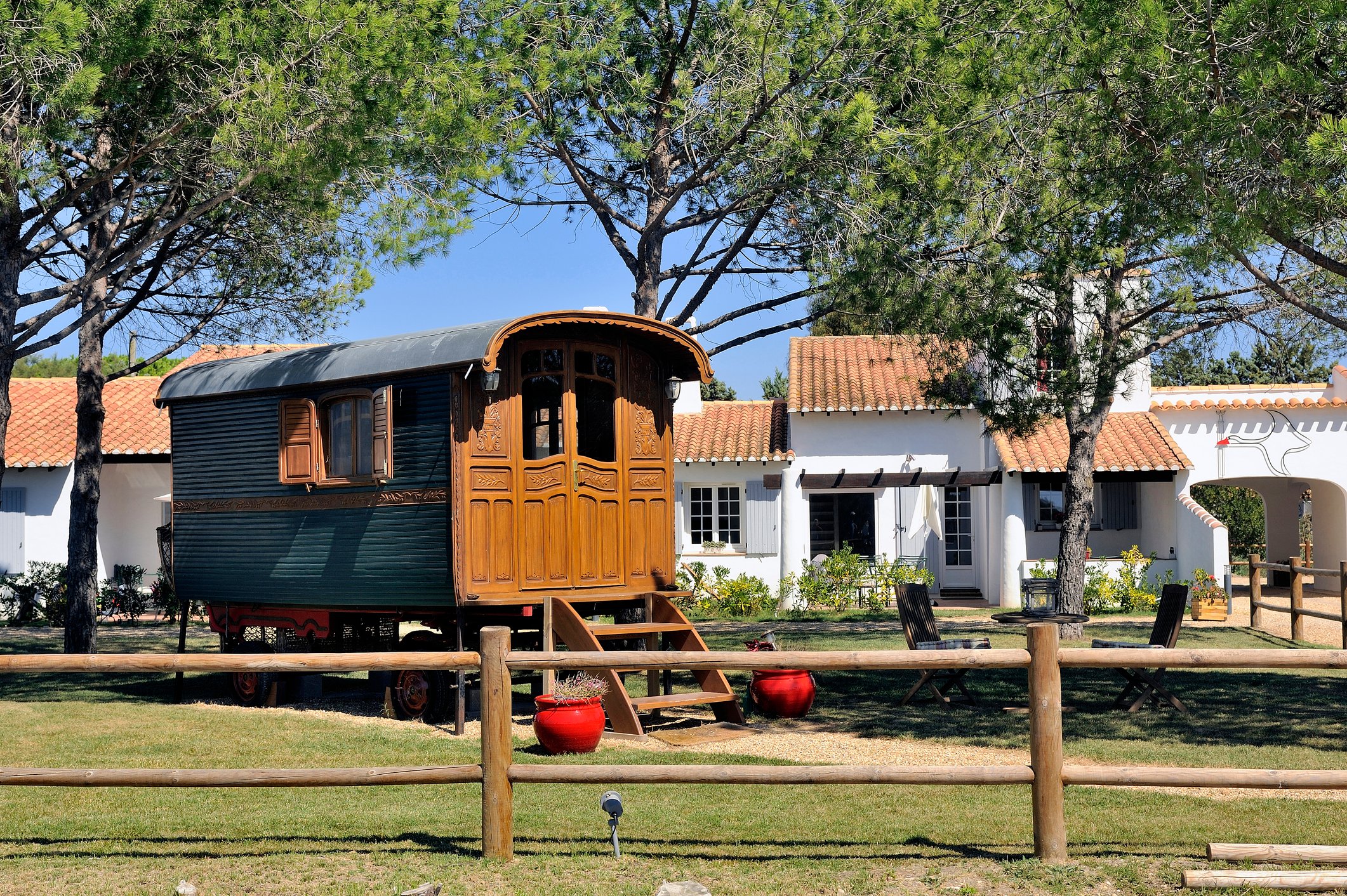 A tiny home in the shape of a wooden wagon.