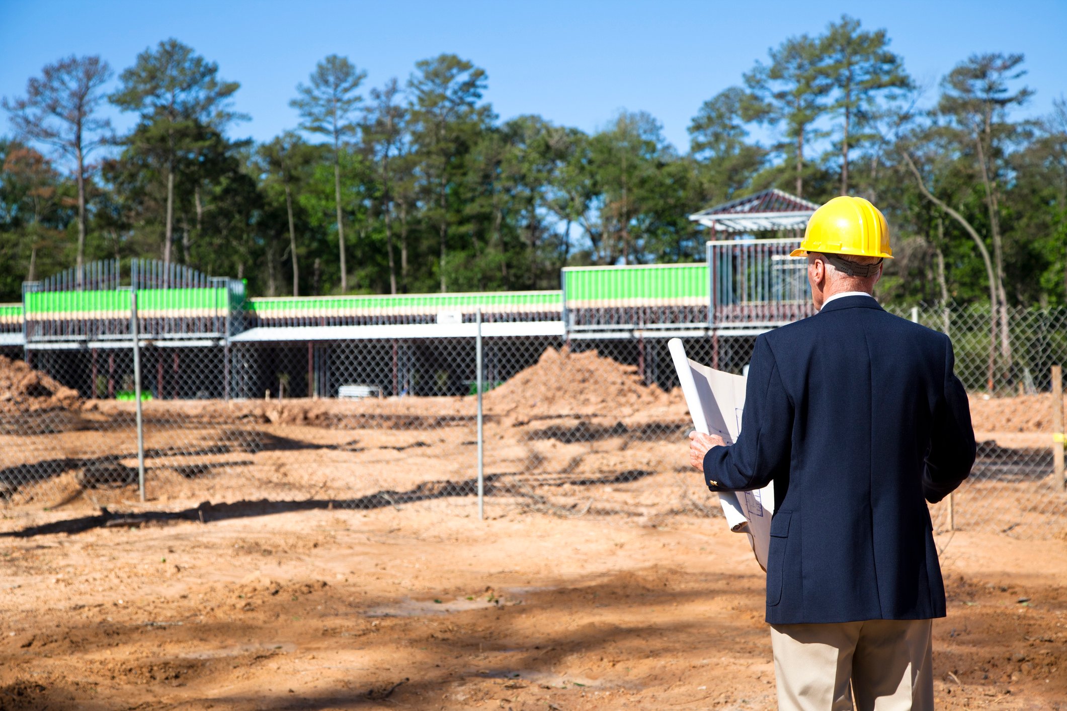 contractor standing in front of strip mall development