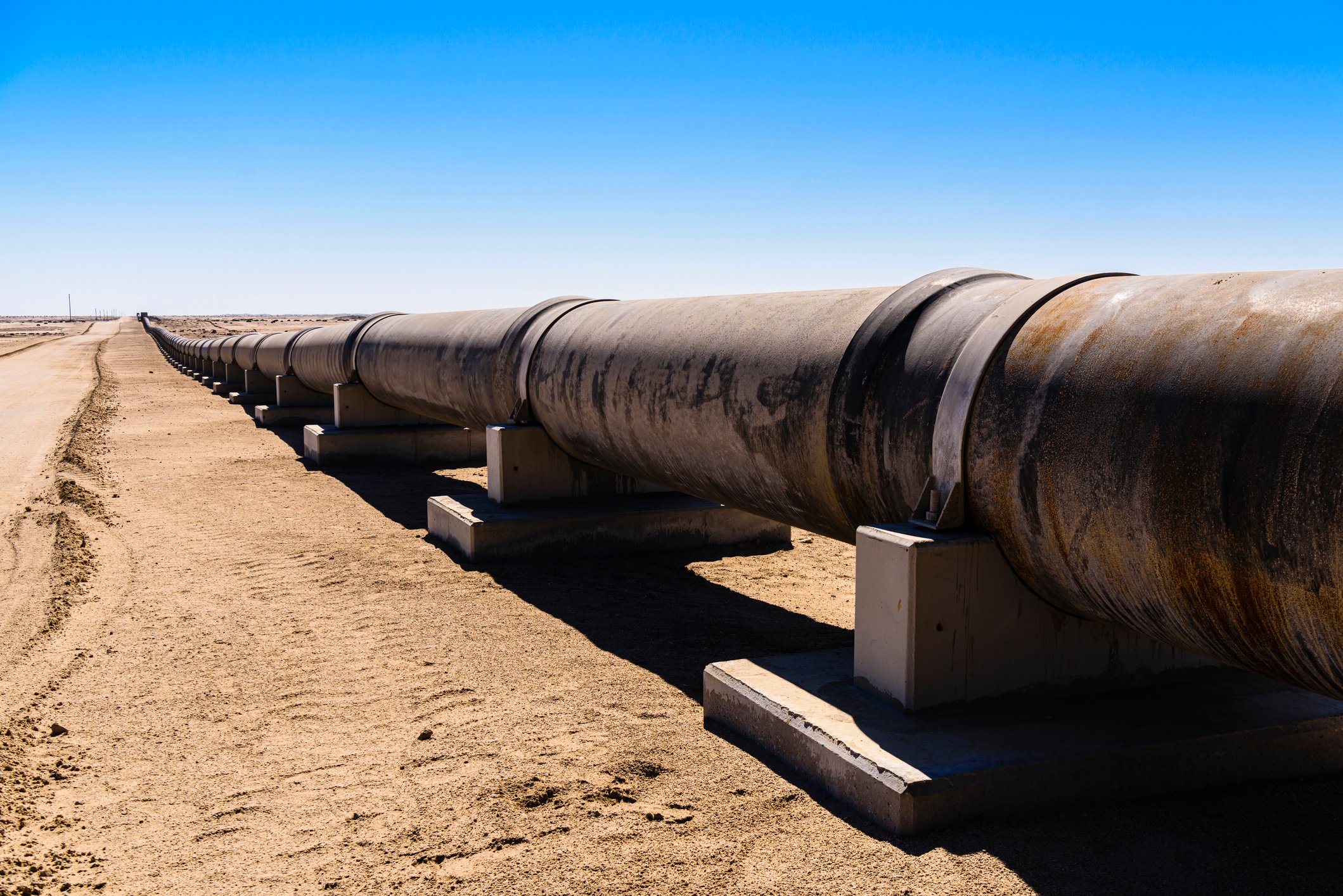 Large steel pipe in a desert landscape.