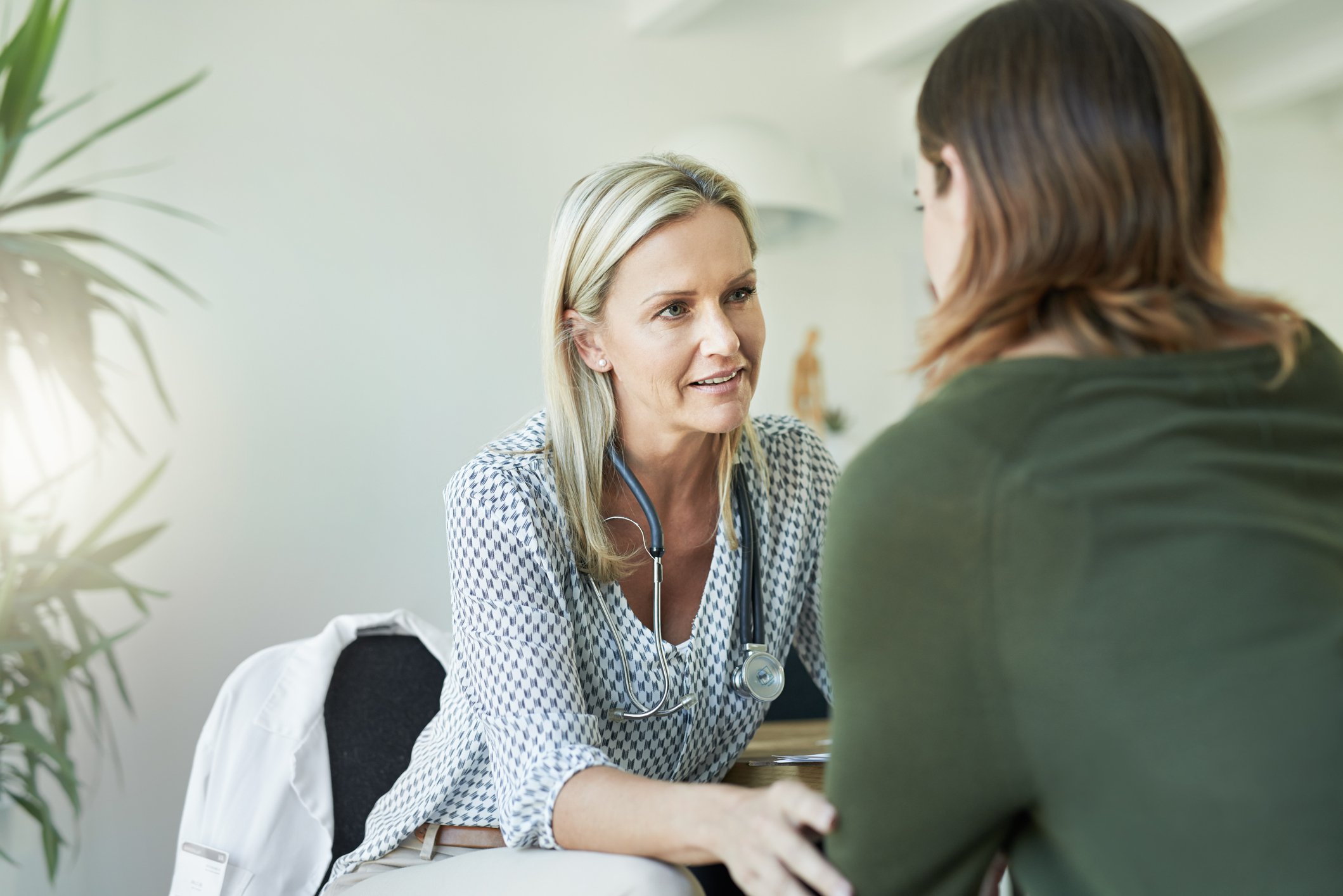 A doctor consults with a patient.