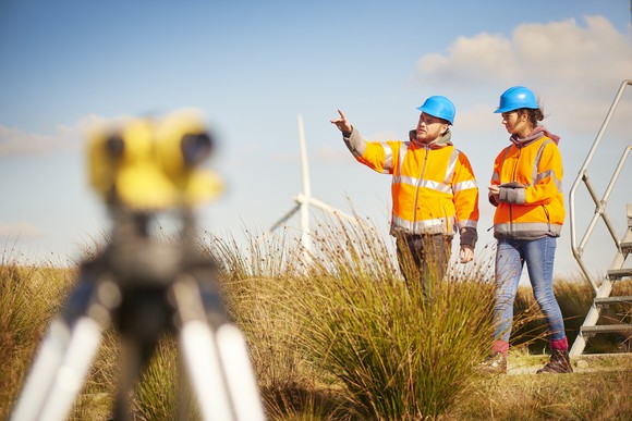 People near a wind turbine.