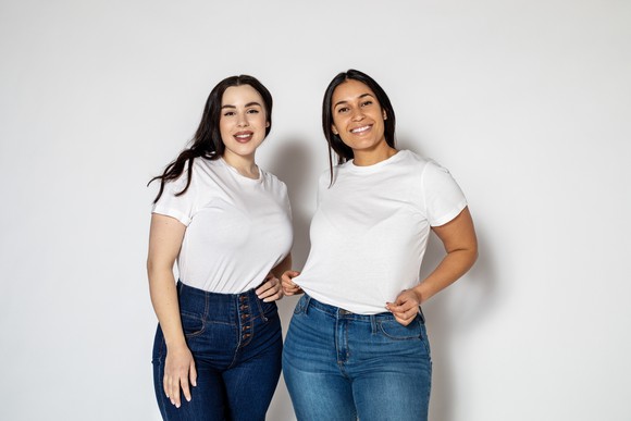 Two women wearing jeans and t-shirts
