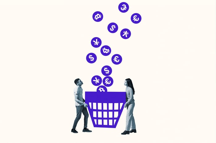 Two people holding bin with money falling in.