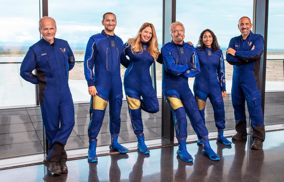 The crew of Unity, including Virgin Galactic founder Richard Branson, poses in their flight suits.