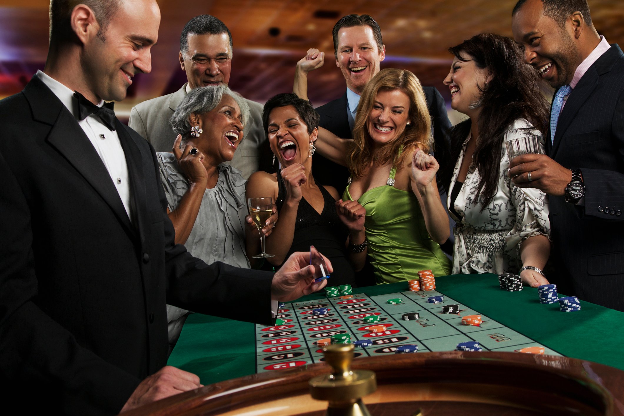 A group of folks at the roulette table.