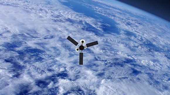 A satellite in orbit over a cloudy earth.