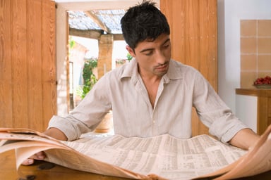 Man Reading Financial Newspaper Stocks Getty