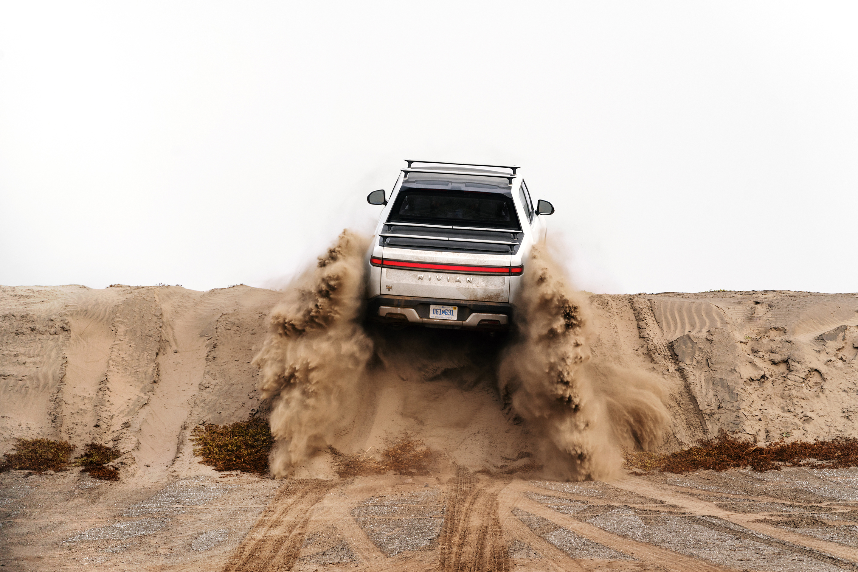 Rivian R1T on a dirt hill. 