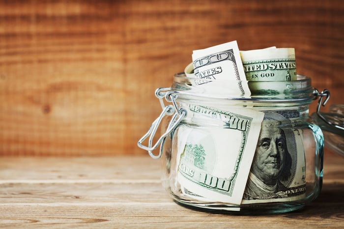 Jar full of hundred dollar bills.