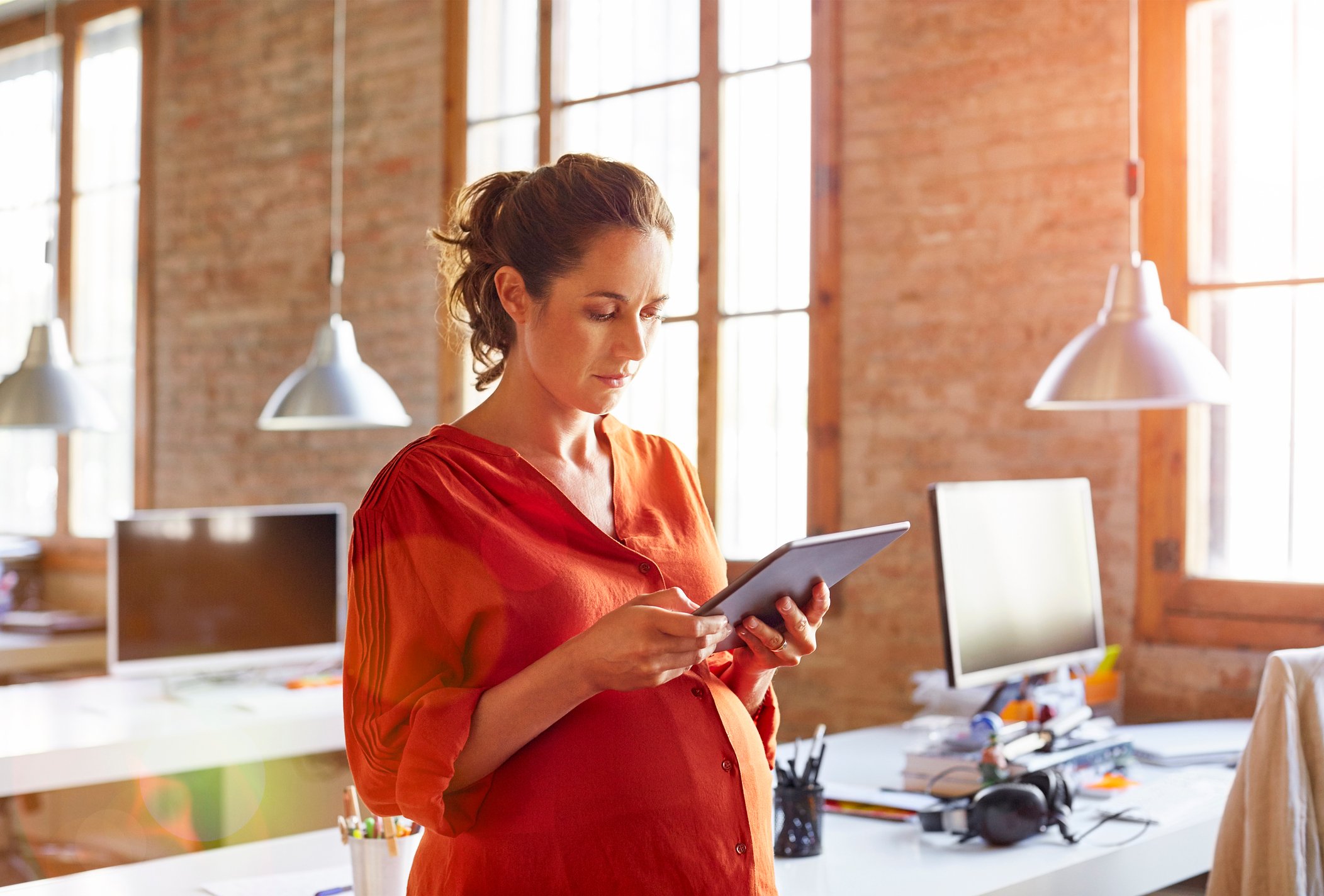 An investor looks at something on her tablet in an office.
