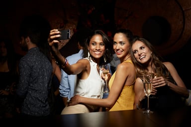 young women at a party taking a selfie
