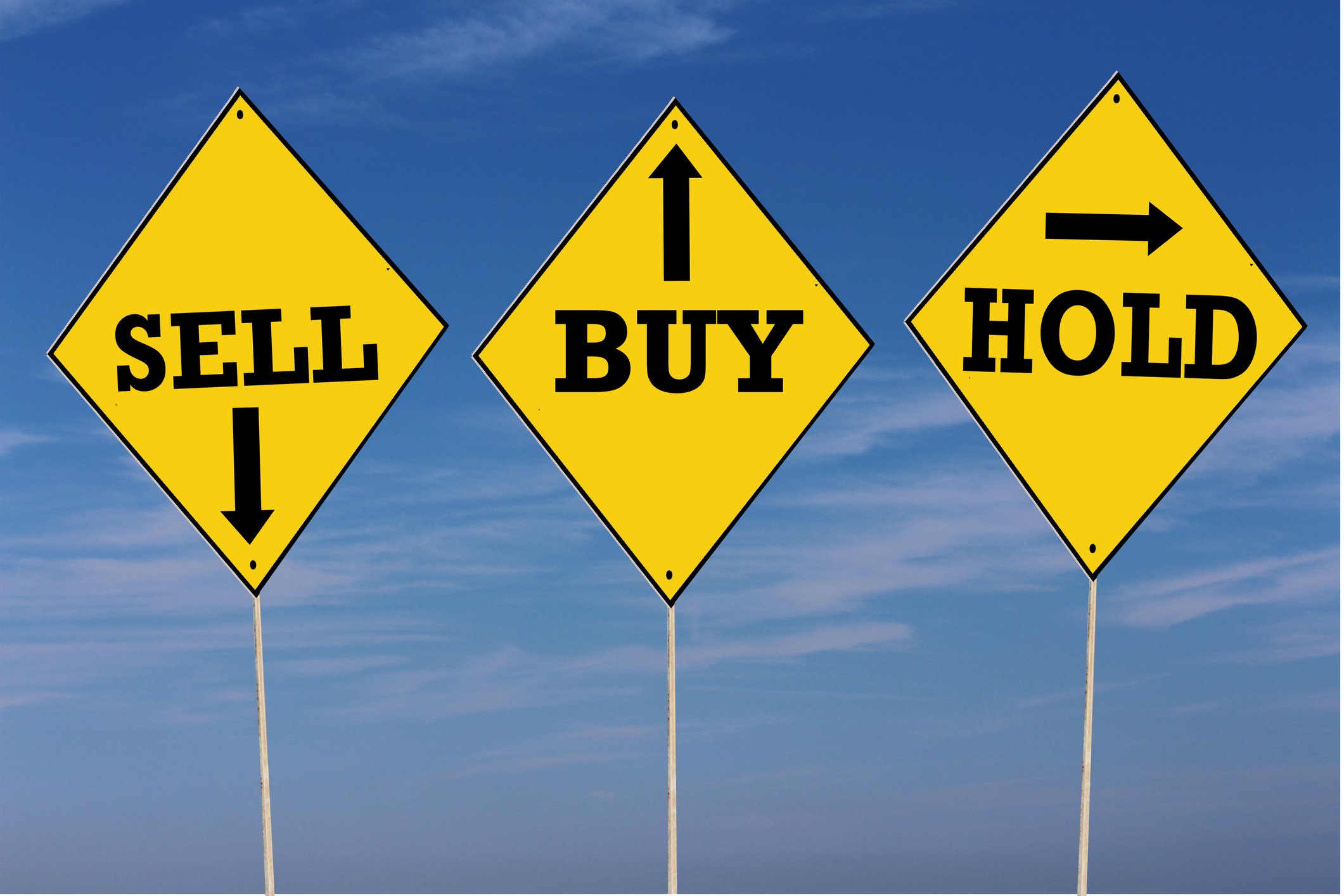 Road signs labeled sell, buy, and hold. 