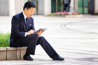 Man-in-suit-reacts-tablet