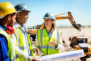 Workers discuss plans at a quarry.