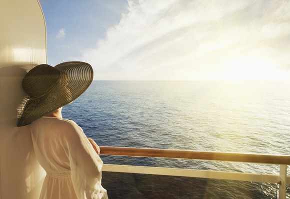 Woman in hat on the deck of a cruise ship.