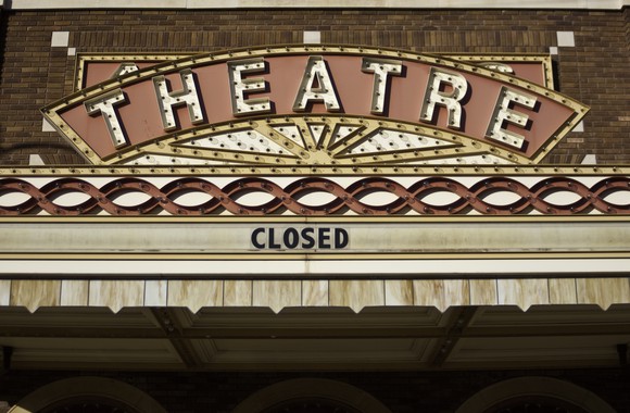 Movie theater marquee displaying the word: closed.