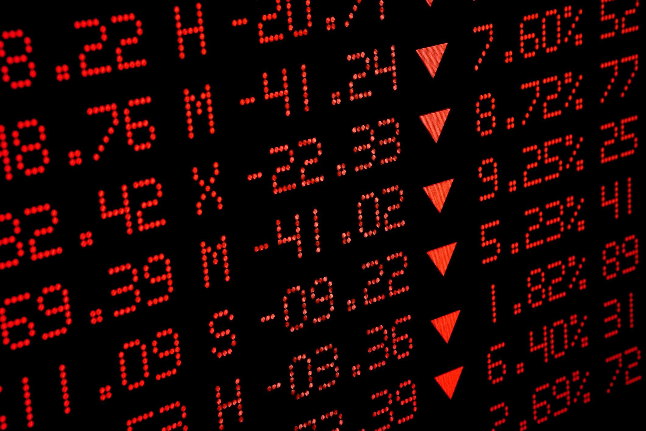 Stock ticker in all red showing declining prices. 