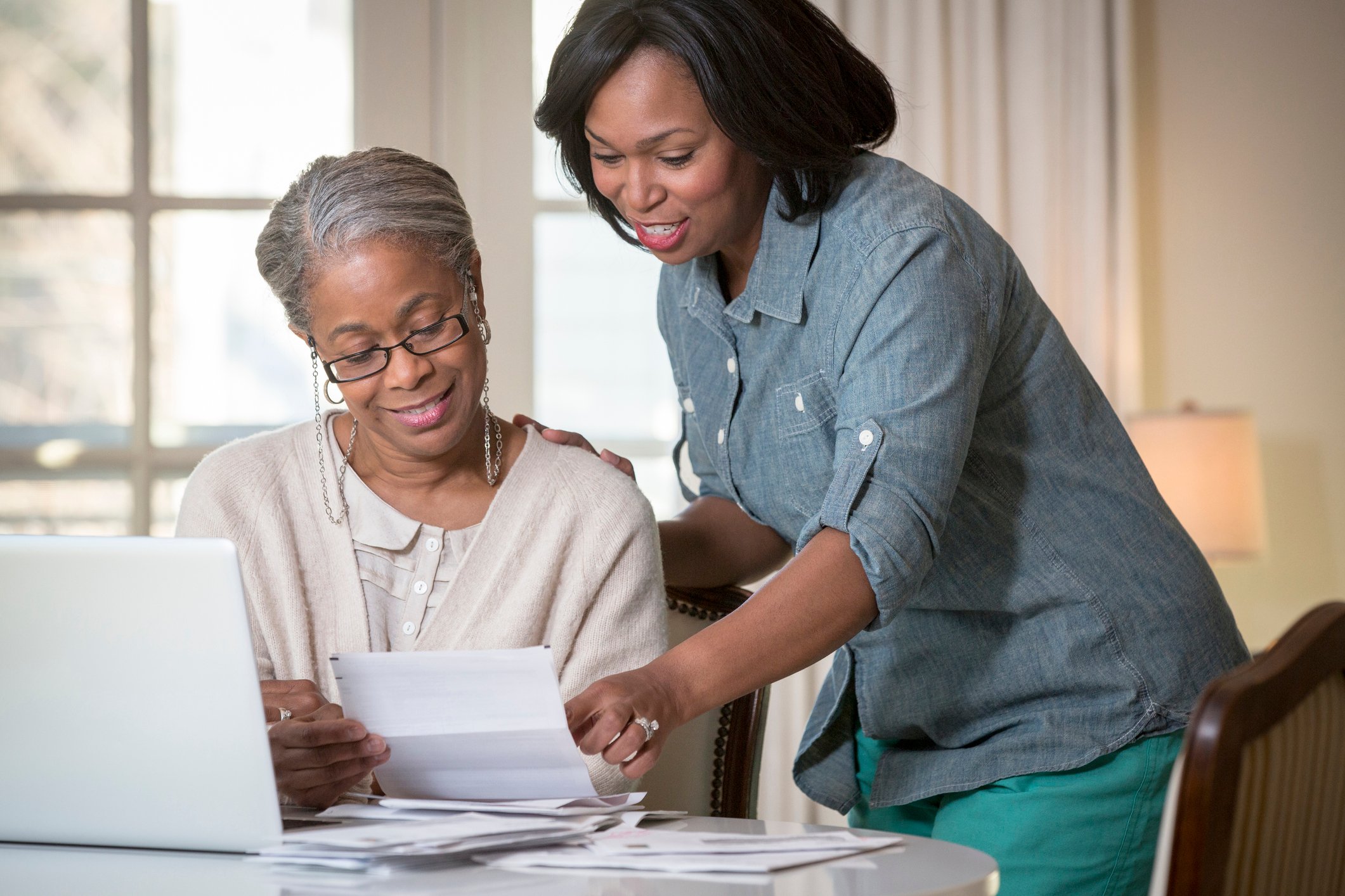 Two people reviewing a paper document.