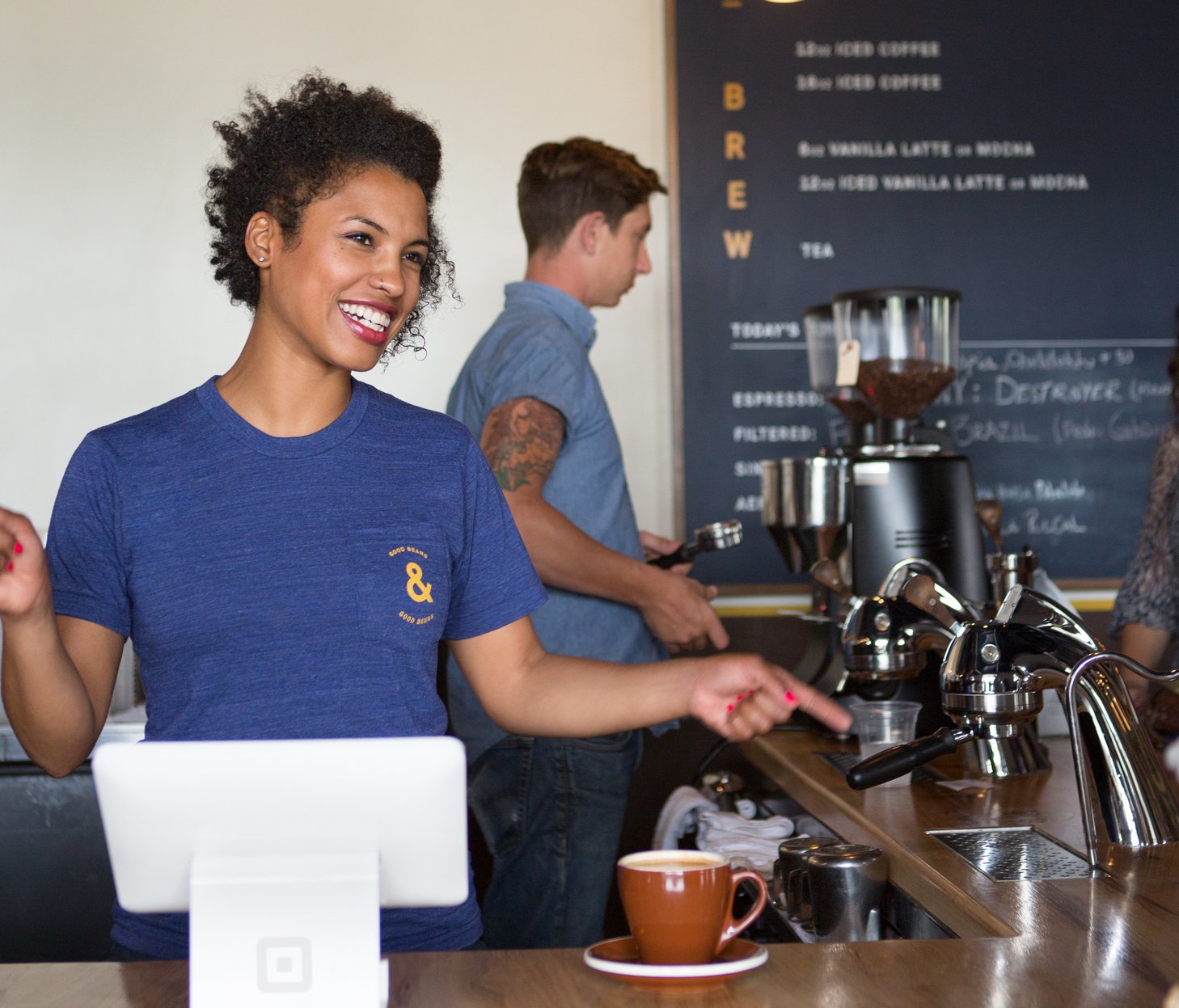 Barista at a coffee shop using Square hardware.