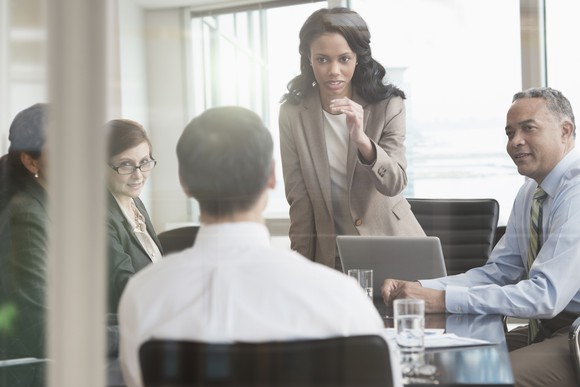 Businesswoman talking with a colleague in a meeting.