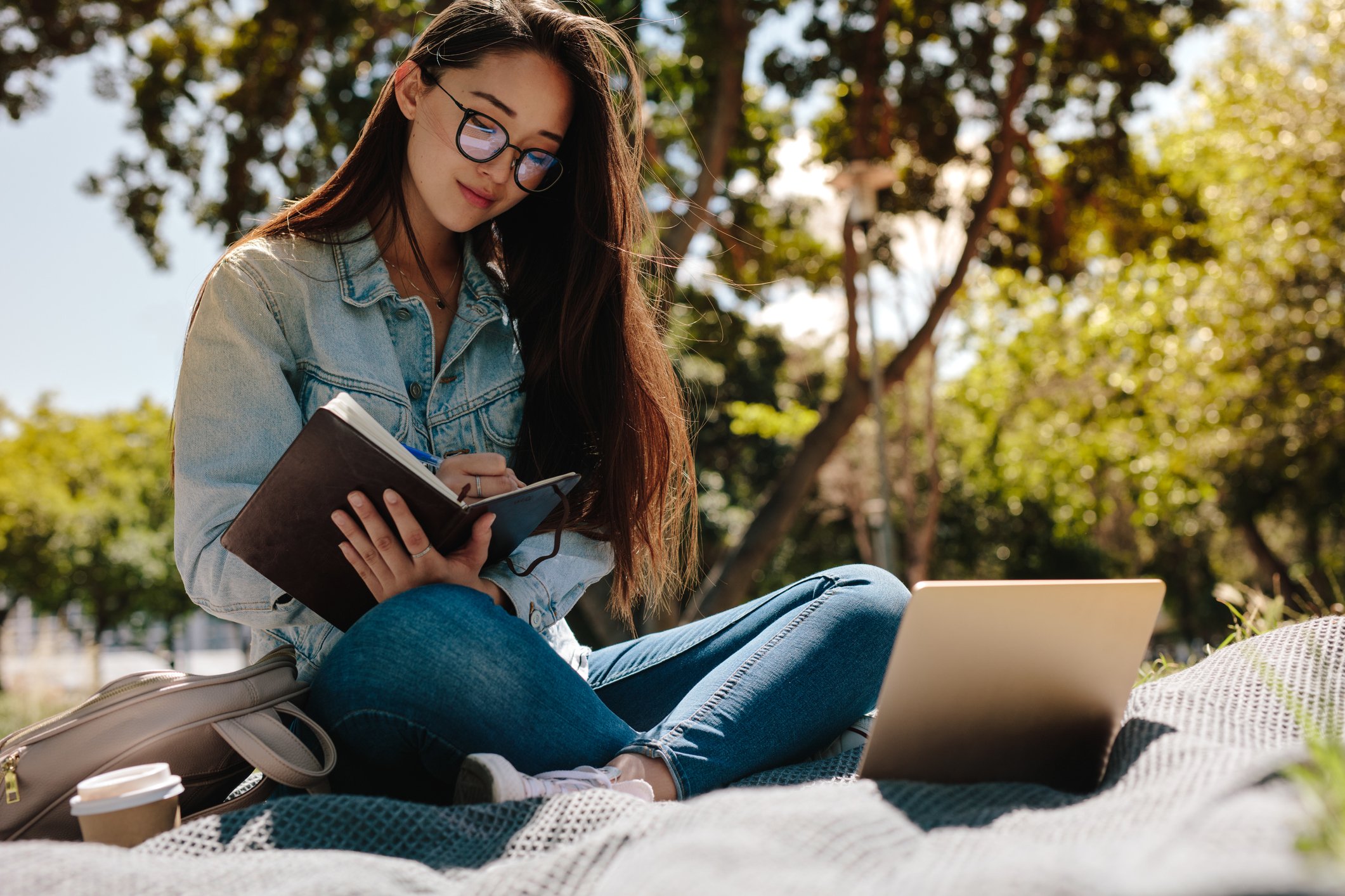 A woman studying outside.