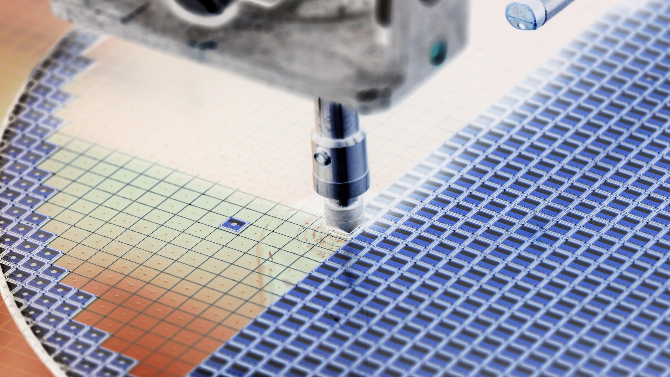 A machine deposits material onto a semiconductor wafer. 