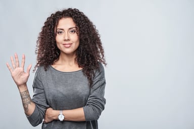 Smiling woman showing five fingers