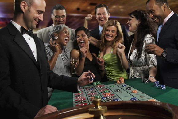 A group of folks playing roulette. 