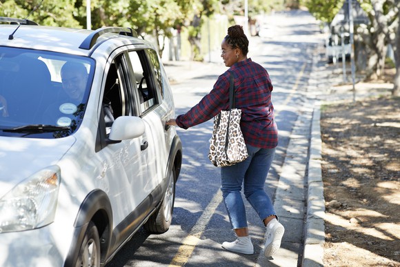 A person hailing a ride from a ride-share app. 
