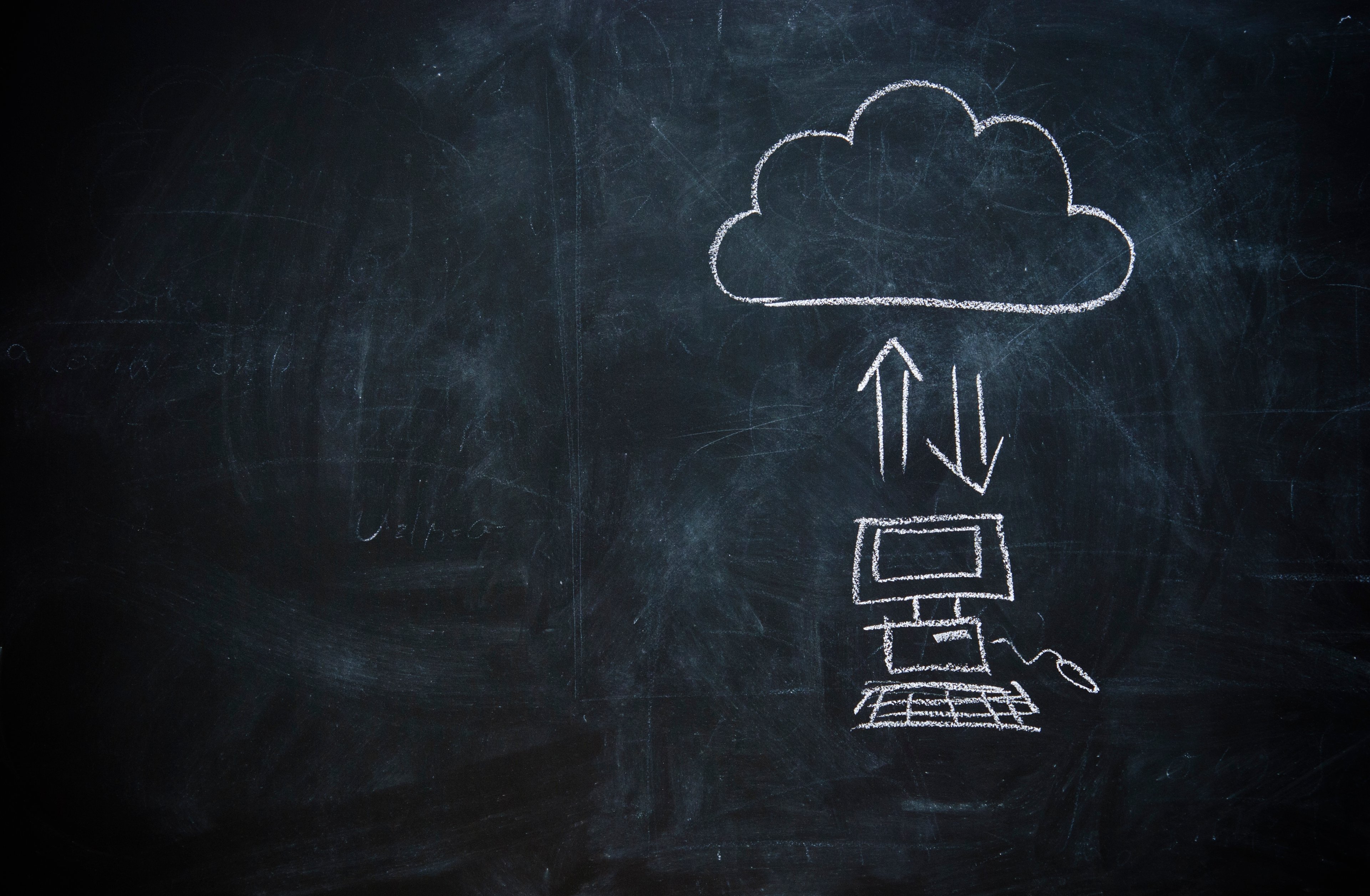 A chalkboard drawing of files being uploaded to the cloud. 